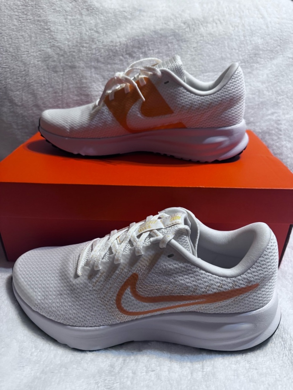 Nike White Athletic Sneakers with Orange Swoosh Accent